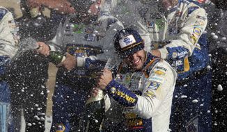 Chase Elliott celebrates his victory with his pit crew after winning a NASCAR Cup Series auto race at Watkins Glen International, Sunday, Aug. 4, 2019, in Watkins Glen, N.Y. (AP Photo/John Munson)