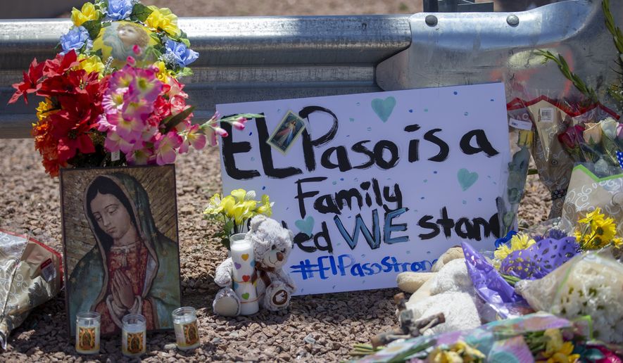 Flowers and a Virgin Mary painting adorn makeshift memorial for the victims of Saturday mass shooting at a shopping complex in El Paso, Texas, Sunday, August 4, 2019. (AP Photo/Andres Leighton)
