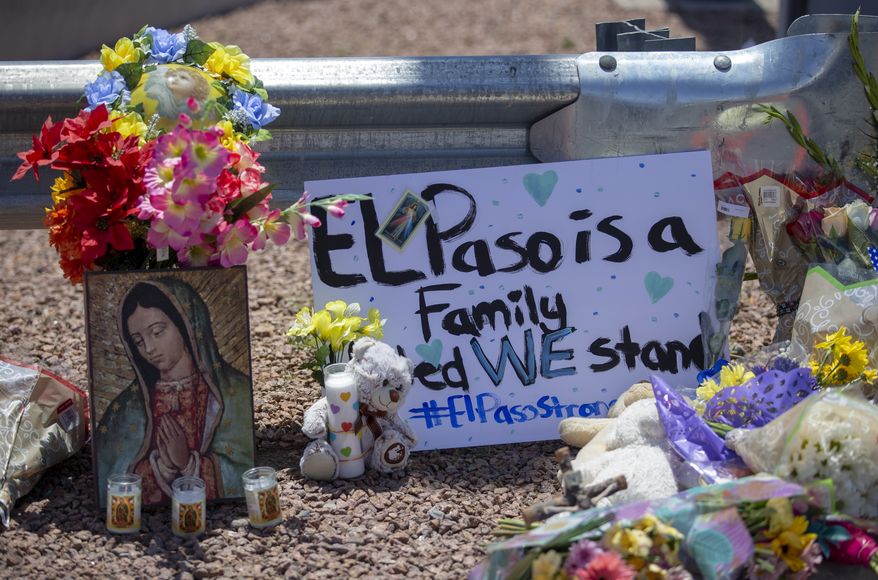 Flowers and a Virgin Mary painting adorn makeshift memorial for the victims of Saturday mass shooting at a shopping complex in El Paso, Texas, Sunday, August 4, 2019. (AP Photo/Andres Leighton)
