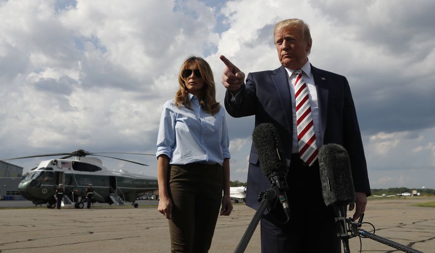 President Donald Trump, with first lady Melania Trump, spoke to the media Sunday before boarding Air Force One about two mass shootings this weekend. (Associated Press)