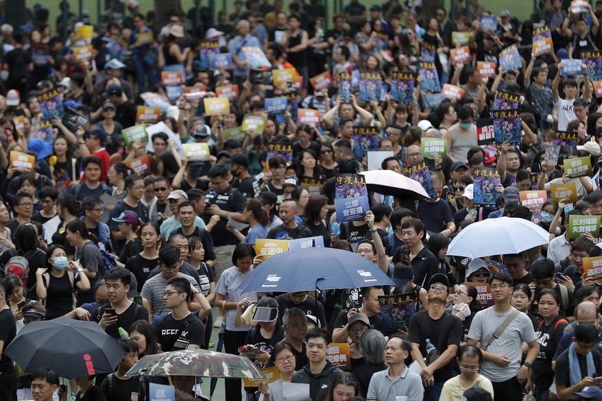 Protesters gather at Po Tsui park as they take part in the anti-extradition bill protests march in Hong Kong, Sunday, Aug. 4, 2019. Hong Kong police said Sunday that they arrested more than 20 people for unlawful assembly, assault and other offences after confrontations between protesters and authorities continued deep into the night. (AP Photo/Vincent Thian)