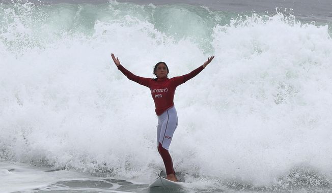 Daniella Rosas, of Peru celebrates, after wining the gold for shortboard during women&#x27;s SUP surfing during the Pan American Games on Punta Rocas beach in Lima Peru, Sunday, Aug. 4, 2019. (AP Photo/Martin Mejia)