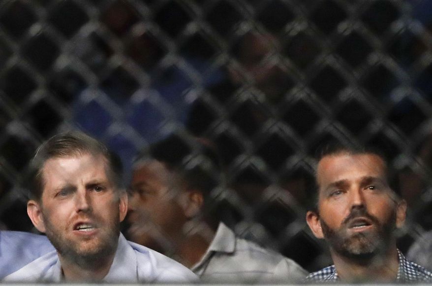 Eric Trump, left, and Donald Trump Jr. watch during the second round of a welterweight mixed martial arts bout between Robbie Lawler and Colby Covington at UFC Fight Night on Saturday, Aug. 3, 2019, in Newark, N.J. Covington won the bout. (AP Photo/Frank Franklin II) **FILE**