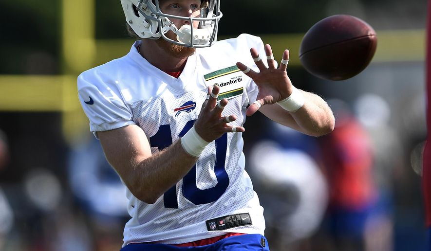 FILE - In this July 25, 2019, file photo, Buffalo Bills wide receiver Cole Beasley catches a pass during practice at the NFL football team&#39;s training camp in Pittsford, N.Y. In Buffalo, Beasley is being asked to play a central role in what had been a patchwork offense that underwent a major overhaul in free agency this offseason. (AP Photo/Adrian Kraus, File)