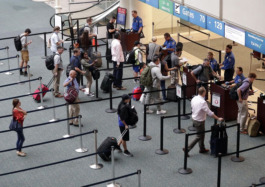 In this June 21, 2018 photo air passengers heading to their departure gates enter TSA pre-check before going through security screening at Orlando International Airport, in Orlando, Fla. On Oct. 22, 2019, a three-judge panel in the 9th U.S. Circuit Court of Appeals ruled unanimously to uphold the U.S. government's no-fly list. (AP Photo/John Raoux)