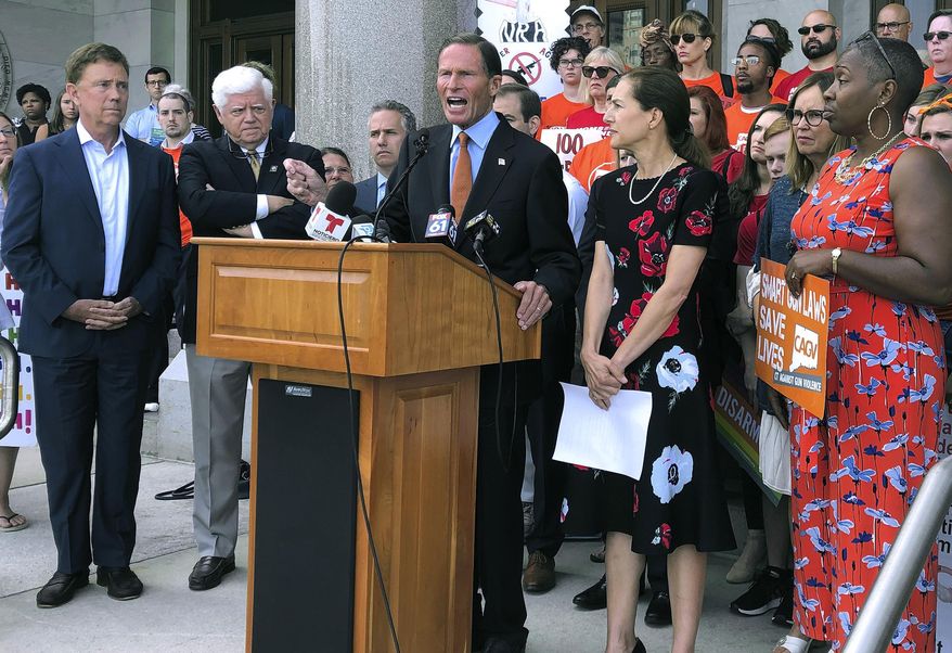 Senator Richard Blumenthal, center, speaks Monday, Aug. 5, 2019, outside the Capitol in Hartford, Conn., surrounded by Connecticut Gov. Ned Lamont, left, U.S. Rep. John Larson, second from left, Lt. Gov. Susan Bysiewicz, second from right, and state Rep. Robyn Porter, D-New Haven, right. The political delegation and gun safety groups rallied to urge the U.S. Senate to return immediately to Washington and follow the state's lead in passing stricter gun laws. (AP Photo/Susan Haigh)