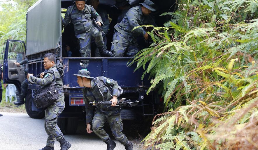 Members of General Operations Force arrive to join a search operation for a missing15-year-old London schoolgirl at The Dusun resort in Seremban, Negeri Sembilan, Malaysia, Monday, Aug. 5, 2019. Police in Malaysia say they do not yet have any signs of foul play in the disappearance of the London schoolgirl, but investigations are ongoing. (AP Photo/Lai Seng Sin)