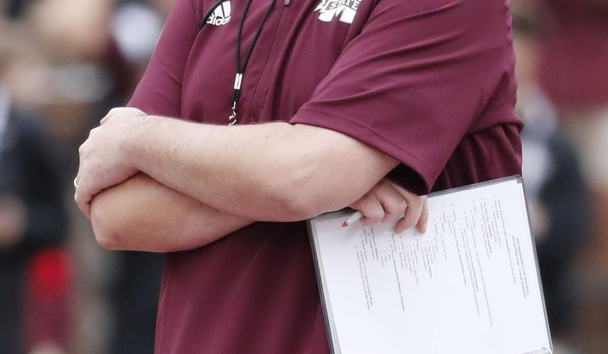 FILE - In this April 13, 2019, file photo, Mississippi State football coach Joe Moorhead observes his team's spring NCAA college football game in Starkville, Miss. The main story of Mississippi State’s preseason camp isn’t hard to find. It’s a two-man quarterback competition between last year’s backup Keytaon Thompson and Penn State transfer Tommy Stevens. The winner will be expected to improve the Bulldogs’ passing offense, which was inconsistent on good days and downright awful on the bad ones last season. (AP Photo/Rogelio V. Solis, File)