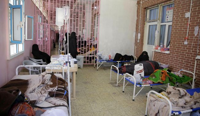 In this March 30, 2019, file photo, women are treated for suspected cholera infection at Al-Sabeen hospital, in Sanaa, Yemen. An Associated Press investigation found some of the United Nations aid workers sent in to Yemen amid a humanitarian crisis caused by five years of civil war have been accused of enriching themselves from an outpouring of donated food, medicine and money. (AP Photo/Hani Mohammed, File)