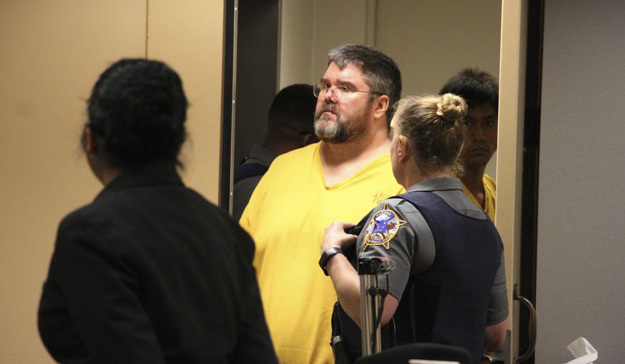 Steven Downs is led into a courtroom for arraignment, Tuesday, Aug. 6, 2019, in Anchorage, Alaska. An attorney entered not-guilty pleas for Downs, who is charged in the 1993 sexual assault and murder of 20-year-old Sophie Sergie on the University of Alaska Fairbanks campus. Authorities say DNA linked Downs to the crime. He was arrested in February in Maine and fought extradition to Alaska. (AP Photo/Mark Thiessen)