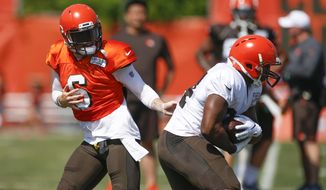 FILE - In this Aug. 5, 2019, file photo, Cleveland Browns quarterback Baker Mayfield (6) hands off to running back Nick Chubb (24) during practice at the NFL football team&#39;s training facility, in Berea, Ohio. Despite an embarrassment of offensive weapons, including Baker Mayfield and Odell Beckham Jr., Browns coach Freddie Kitchens made it clear his team won’t be “pass happy” this season. Not as long as he’s got Nick Chubb, who ran for 996 yards as a rookie and could be on the verge of becoming one of the NFL’s top backs. (AP Photo/Ron Schwane, File)