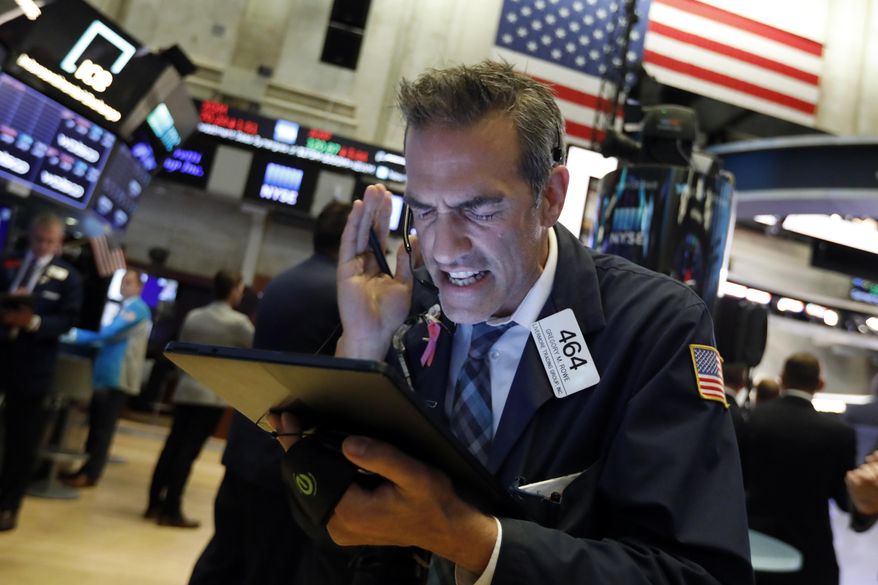 Trader Gregory Rowe works on the floor of the New York Stock Exchange, Monday, Aug. 5, 2019. Stocks plunged on Wall Street Monday on worries about how much President Donald Trump's escalating trade war with China will damage the economy. (AP Photo/Richard Drew)