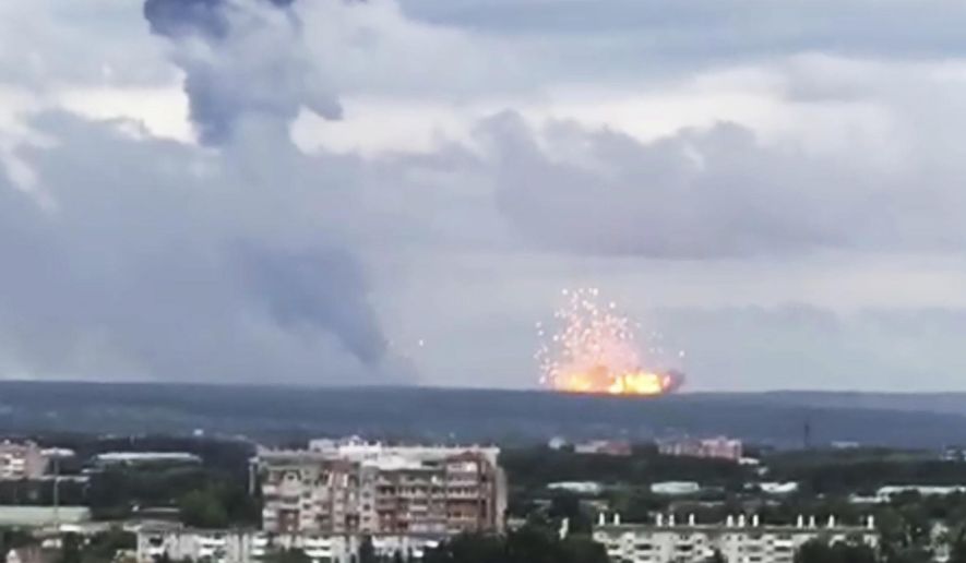 In this image taken from video, explosions are seen at the military base, about 10 kilometers from Achinsk, Krasnoyarsk region, Russia Far East, Monday, Aug. 5, 2019. An explosion at a Russian military base in Siberia has set off fires and injured at several people. (Liza Uskova via AP)