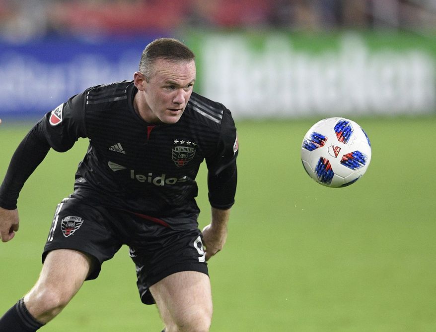 FILE - In this file photo dated Sunday, Aug. 12, 2018, D.C. United forward Wayne Rooney, in action against Orlando City during the second half of an MLS soccer match, in Washington, USA. It is announced Tuesday Aug. 6, 2019, that 33-year old former England captain Wayne Rooney will be leaving US Major League Soccer to join second-tier English Championship team Derby County as player-coach from January 2020. (AP Photo/Nick Wass, FILE)