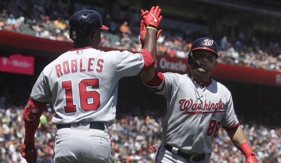 Washington Nationals&#39; Gerardo Parra, right, is congratulated by Victor Robles after hitting a three-run home run that scored Adam Eaton and Juan Soto against the San Francisco Giants during the third inning of a baseball game in San Francisco, Wednesday, Aug. 7, 2019. (AP Photo/Jeff Chiu)