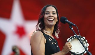 TAKES OUT REFERENCE TO PIONEERING COMPOSER - FILE - In this Tuesday, July 3, 2018, file photo, Rhiannon Giddens performs during rehearsal for the Boston Pops Fireworks Spectacular in Boston. Grammy-winning folk singer and musician Giddens and the late Frank Johnson, the leader of a 19th century black brass band, will be the first recipients of the inaugural Legacy of Americana Award, on Sept. 11, 2019, in Nashville, Tenn.  (AP Photo/Michael Dwyer, File)