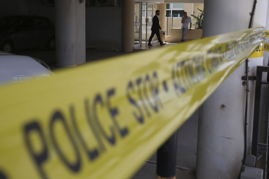 A man walks out from Famagusta district court house in southeast town of Paralimni, Cyprus, Wednesday, Aug. 7, 2019. The lawyer representing a 19-year-old British woman who faces a public nuisance charge for falsely accusing 12 Israelis of rape has withdrawn from the case because of a "serious disagreement" with his client. (AP Photo/Petros Karadjias)