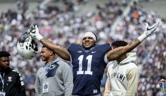 FILE - In this April 21, 2018, file photo, Penn State linebacker Micah Parsons acknowledges the crowd before the Blue-White spring college football game in State College, Pa. Last year, Parsons put together the greatest freshman season for a linebacker in Penn State’s long history. He says he learned that earning a starting spot takes more than making a bunch of tackles.  (Joe Hermitt/PennLive.com via AP)