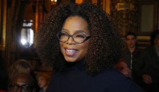 FILE - This March 4, 2019 file photo shows Oprah Winfrey at the presentation of Stella McCartney&#39;s ready-to-wear Fall-Winter 2019-2020 fashion collection in Paris. Winfrey praised her late friend and idol, Toni Morrison, hailing the best-selling author’s “confidence and self-assuredness and nobility.” Winfrey and Morrison knew each other for more than 20 years, dating back to when Winfrey was so determined to learn the author’s unlisted phone number that she called the local fire department. (AP Photo/Michel Euler, File)