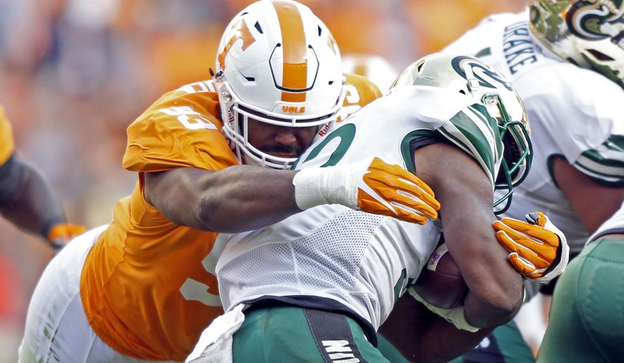 FILE - In this Nov. 3, 2018, file photo, Tennessee defensive lineman Emmit Gooden (93) tackles Charlotte running back Benny LeMay (32) during the first half of an NCAA college football game in Knoxville, Tenn. Gooden will miss the entire season with a knee injury, leaving the Volunteers without their most experienced player on a defensive line that has no returning starters. Vols coach Jeremy Pruitt says Gooden tore his anterior cruciate ligament Tuesday, Aug. 6, and will undergo surgery next week. (AP Photo/Wade Payne, File)
