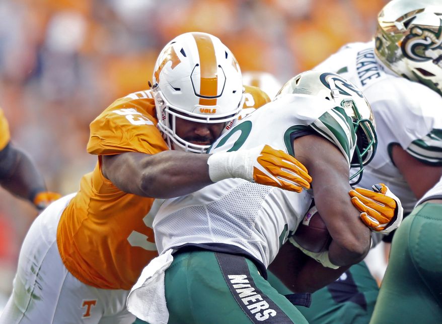FILE - In this Nov. 3, 2018, file photo, Tennessee defensive lineman Emmit Gooden (93) tackles Charlotte running back Benny LeMay (32) during the first half of an NCAA college football game in Knoxville, Tenn. Gooden will miss the entire season with a knee injury, leaving the Volunteers without their most experienced player on a defensive line that has no returning starters. Vols coach Jeremy Pruitt says Gooden tore his anterior cruciate ligament Tuesday, Aug. 6, and will undergo surgery next week. (AP Photo/Wade Payne, File)