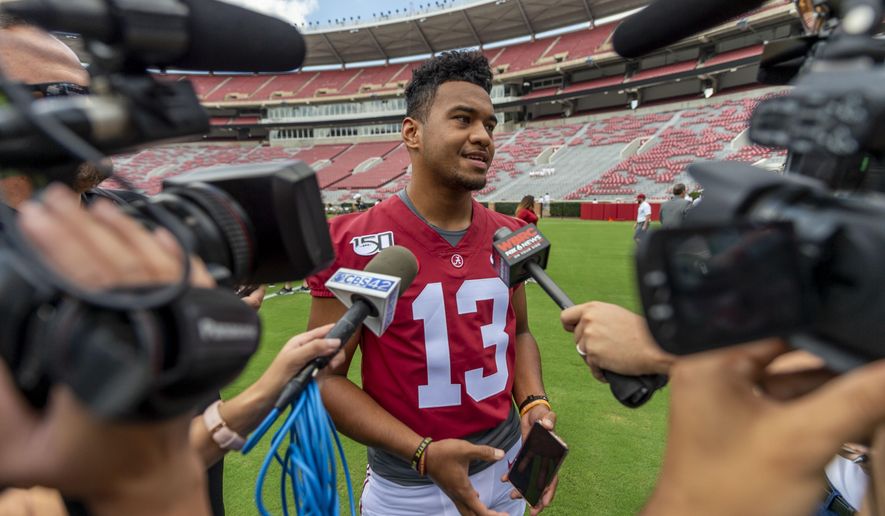 Alabama quarterback Tua Tagovailoa (13) talks with the media prior to Alabama's fall camp fan-day college football scrimmage, Saturday, Aug. 3, 2019, at Bryant-Denny Stadium in Tuscaloosa, Ala. (AP Photo/Vasha Hunt)