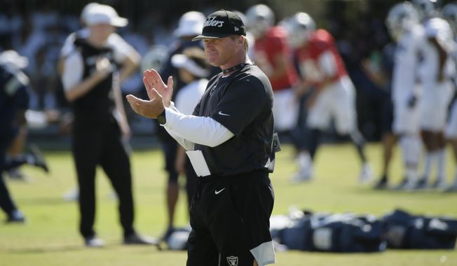 Oakland Raiders head coach Jon Gruden claps during NFL football training camp Thursday, Aug. 8, 2019, in Napa, Calif. Both the Oakland Raiders and the Los Angeles Rams held a joint practice before their upcoming preseason game on Saturday. (AP Photo/Eric Risberg)