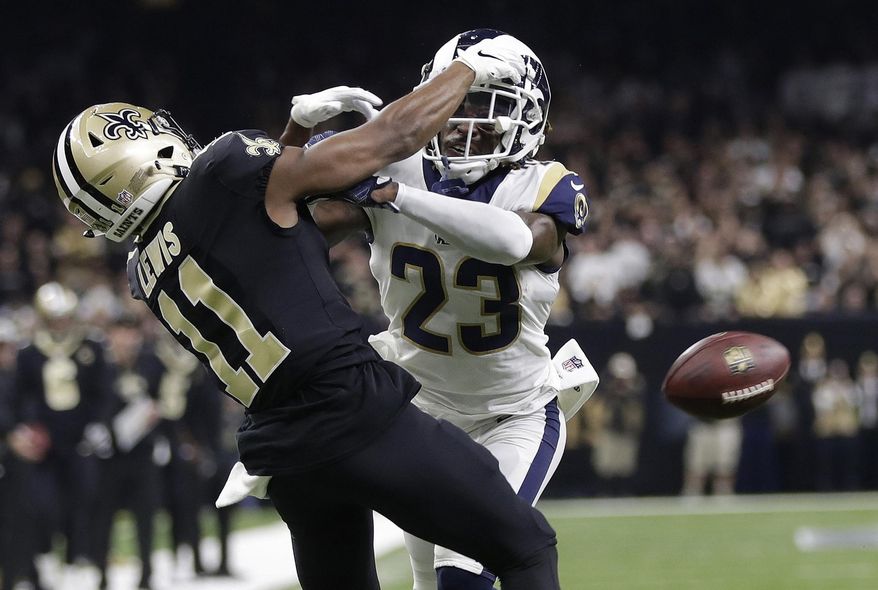FILE - In this Jan. 20, 2019, file photo, Los Angeles Rams' Nickell Robey-Coleman breaks up a pass intended for New Orleans Saints' Tommylee Lewis during the second half of the NFL football NFC championship game in New Orleans. They were badly burned by the “Nola no-call,” but the New Orleans Saints have joined the NFL in opposing a fan’s lawsuit seeking damages over the missed penalty that helped the Los Angeles Rams beat the Saints in a January playoff game and move on to the Super Bowl. (AP Photo/Gerald Herbert, File)