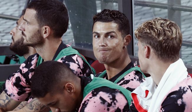 Cristiano Ronaldo, second from right, of Juventus sits on the bench prior to a friendly match against Team K League at the Seoul World Cup Stadium in Seoul, South Korea, Friday, July 26, 2019. (AP Photo/Ahn Young-joon)