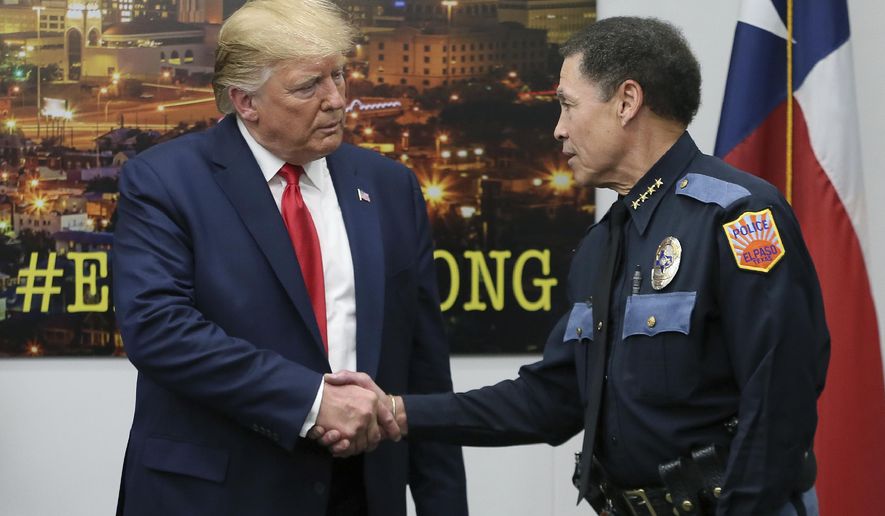 President Donald Trump shakes hands with El Paso Police Chief Greg Allen, Wednesday, Aug. 7, 2019, in El Paso, Texas. Trump paid visits to cities reeling from mass shootings that left multiple people dead and wounded. (Mark Lambie/The El Paso Times via AP)