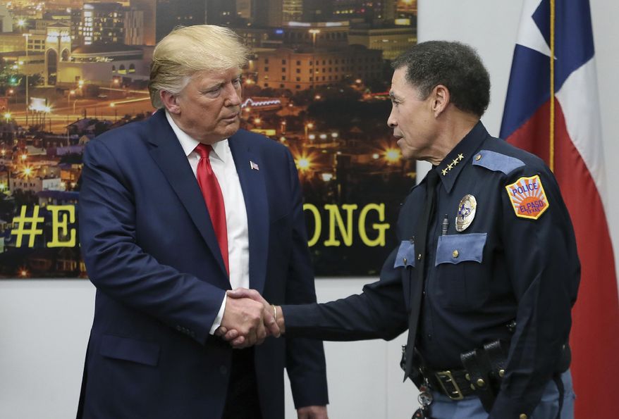 President Donald Trump shakes hands with El Paso Police Chief Greg Allen, Wednesday, Aug. 7, 2019, in El Paso, Texas. Trump paid visits to cities reeling from mass shootings that left multiple people dead and wounded. (Mark Lambie/The El Paso Times via AP)