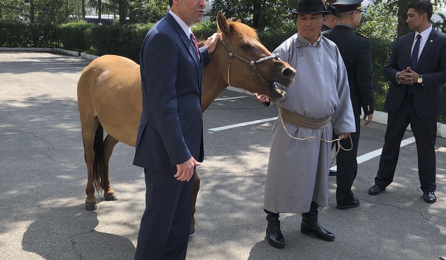 U.S. Defense Secretary Mark Esper, left, poses for a photo with horse “Marshall,&amp;quot; named after Gen. George Marshall, after being presented to him in Ulaanbaatar, Mongolia, Thursday, Aug. 8, 2019. With one hand resting on the mane of a sturdy Mongolian horse, Esper invoked the name of one of America’s great soldiers as he sought to strengthen the military bonds between the U.S. and this landlocked democracy sandwiched between Russia and China. (AP Photo/Lolita Baldor)