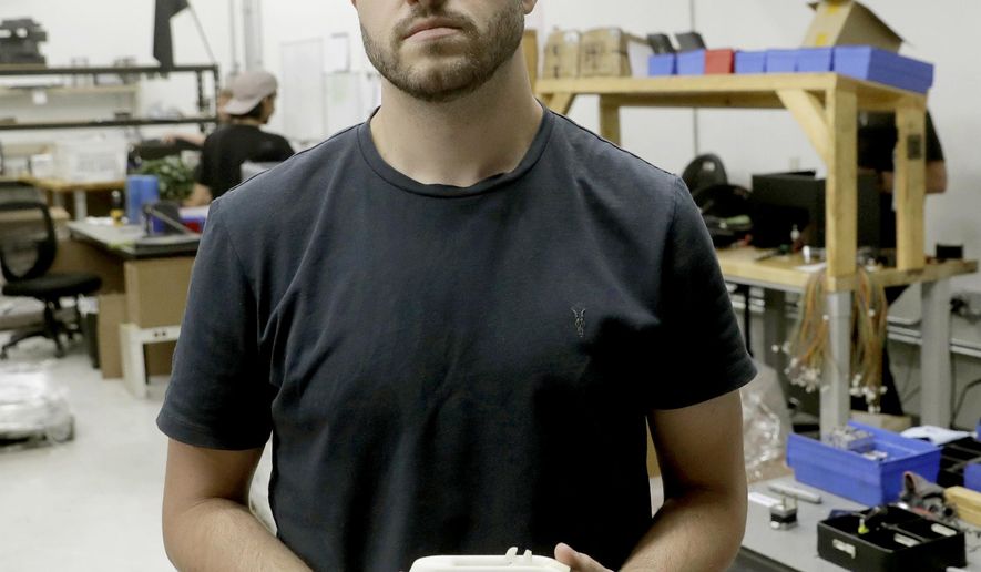 FILE - In this Aug. 1, 2018, file photo, Cody Wilson, with Defense Distributed, holds a 3D-printed gun called the Liberator at his shop, in Austin, Texas. On Friday, Aug. 9, 2019, Wilson, who sparked a nationwide legal fight over the constitutionality of firearms made with a 3D printer, pleaded guilty to having sex with an underage girl. (AP Photo/Eric Gay, File)