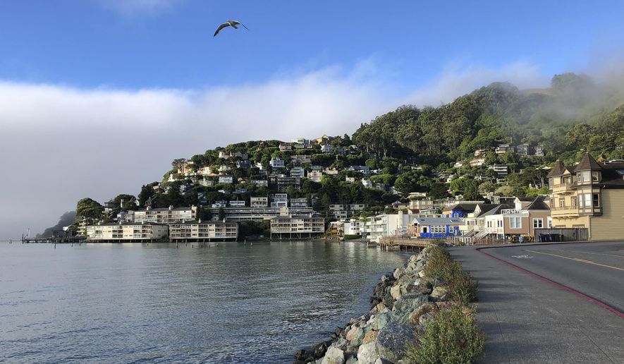 In this photo taken July 11, 2019, fog appears behind the hills of Sausalito, Calif. A school district in one of California's wealthiest counties has agreed to desegregate a flailing school that state officials found was intentionally created for low-income minority children. California Attorney General Xavier Becerra said Friday, Aug. 9, 2019 that the Sausalito Marin City School District outside of San Francisco must develop a plan, scholarship program and counseling for students of Bayside Martin Luther King Jr. Academy. (AP Photo/Eric Risberg)