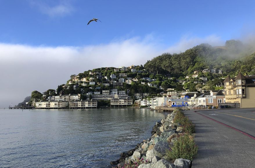 In this photo taken July 11, 2019, fog appears behind the hills of Sausalito, Calif. A school district in one of California's wealthiest counties has agreed to desegregate a flailing school that state officials found was intentionally created for low-income minority children. California Attorney General Xavier Becerra said Friday, Aug. 9, 2019 that the Sausalito Marin City School District outside of San Francisco must develop a plan, scholarship program and counseling for students of Bayside Martin Luther King Jr. Academy. (AP Photo/Eric Risberg)