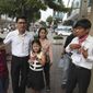 Journalists Uon Chhin, right, and Yeang Sothearin with his children walk to enter the municipal court in Phnom Penh, Cambodia, Friday, Aug. 9, 2019. The two Cambodian journalists who had worked for U.S. government-funded Radio Free Asia were back on trial Friday on espionage charges that rights groups have characterized as a flagrant attack on press freedom. Uon Chhin and Yeang Sothearin are charged with undermining national security by supplying information to a foreign state, which is punishable by up to 15 years in prison. (AP Photo/Heng Sinith)