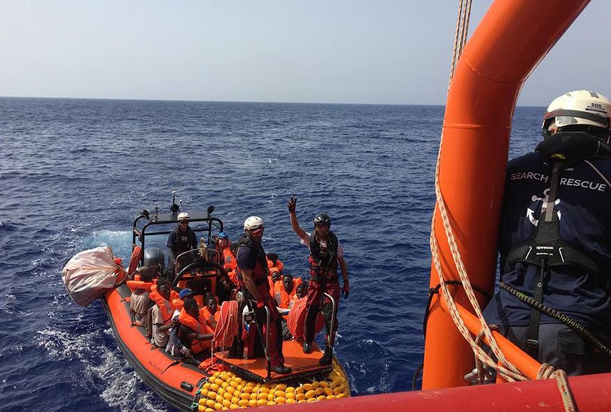 In this photo released Friday, Aug. 9, 2019, some of the 80 migrants rescued from a rubber dinghy off Libya are ferried to the Ocean Viking rescue ship run by the SOS Mediterranee NGO. Italian Interior Minister Matteo Salvini, who has triggered a government crisis in Italy, said he is preparing to sign a ban on the ship's entry into Italian waters. (Photo SOS Mediterranee via AP)