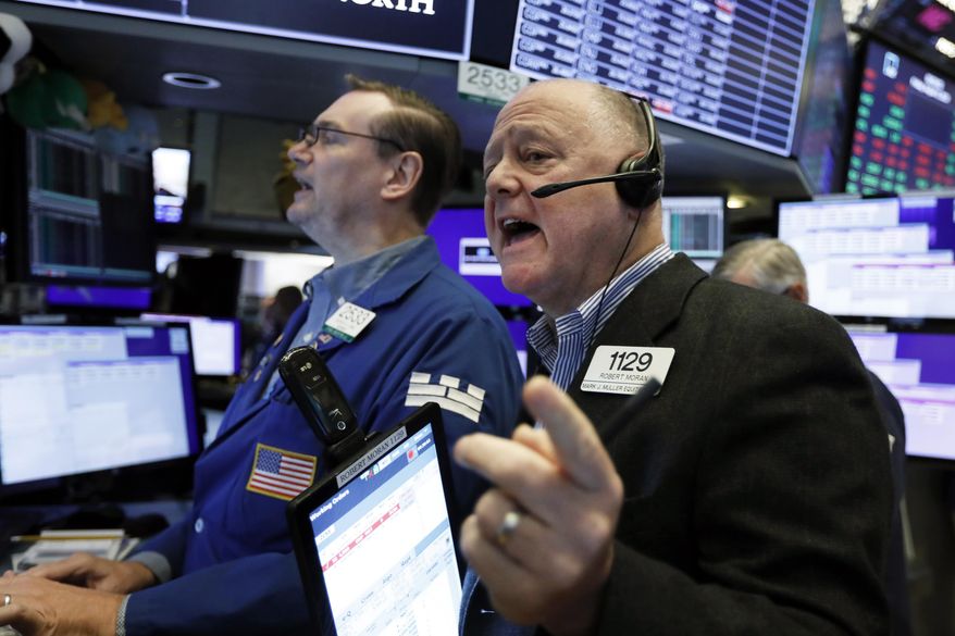 Trader Robert Moran, right, and specialist Patrick King work on the floor of the New York Stock Exchange, Friday, Aug. 9, 2019. Stocks moved broadly lower in early trading On Wall Street Friday as investors again retreated to safer holdings in a market racked by fear and anxiety over trade disputes. (AP Photo/Richard Drew)