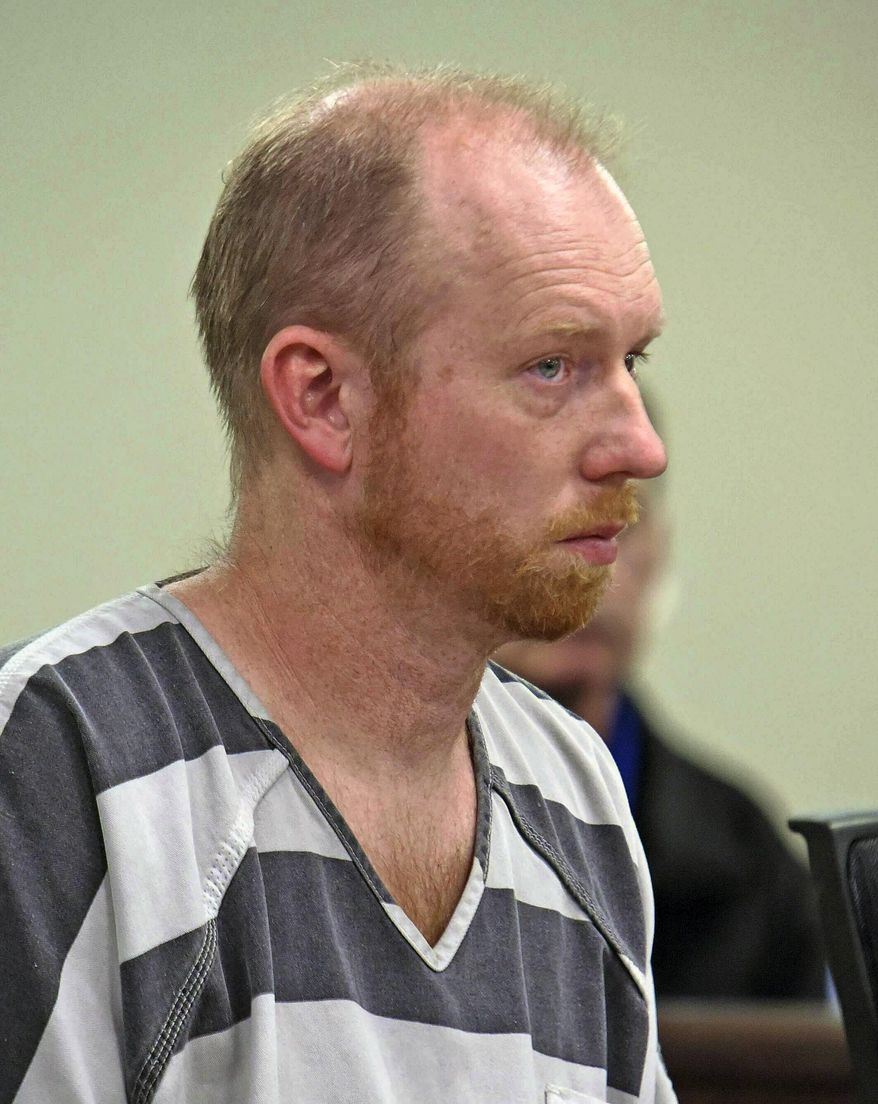 FILE - In this Friday, April 5, 2019 file photo, Chad Isaak listens while being charged with four counts of class AA felony murder in district court in Mandan, N.D. Isaak, accused of killing four people at a North Dakota property management company has waived a preliminary hearing and pleaded not guilty to murder charges. A South Central Judicial District judge signed the waiver and plea Friday, Aug. 9, 2019 for Isaak. (Tom Stromme/The Bismarck Tribune via AP, File)