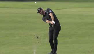 Dustin Johnson drives to the 12th hole in the Northern Trust tournament at Liberty National Golf Course, Thursday, Aug. 8, 2019, in Jersey City, N.J. (AP Photo/Mark Lennihan)