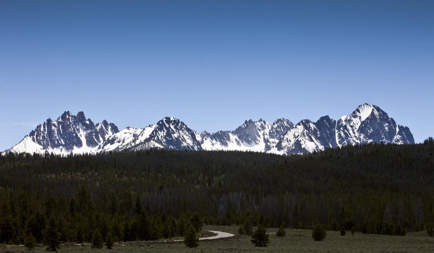 FILE - This June 1, 2012 file photo shows the Sawtooth National Recreation Area near Stanley, Idaho. Central Idaho ranch owners want construction of a proposed trail connecting the popular tourist destinations of Redfish Lake and Stanley stopped and further work to make it a smooth path for hikers and bikers prohibited. Sawtooth Mountain Ranch owners David Boren and Lynn Arnone have been fighting construction of the trail with a federal lawsuit against the U.S. government and on Thursday, Aug. 8, 2019, filed new documents contending the proposed trail violates environmental laws. (Darin Oswald/Idaho Statesman via AP, File)