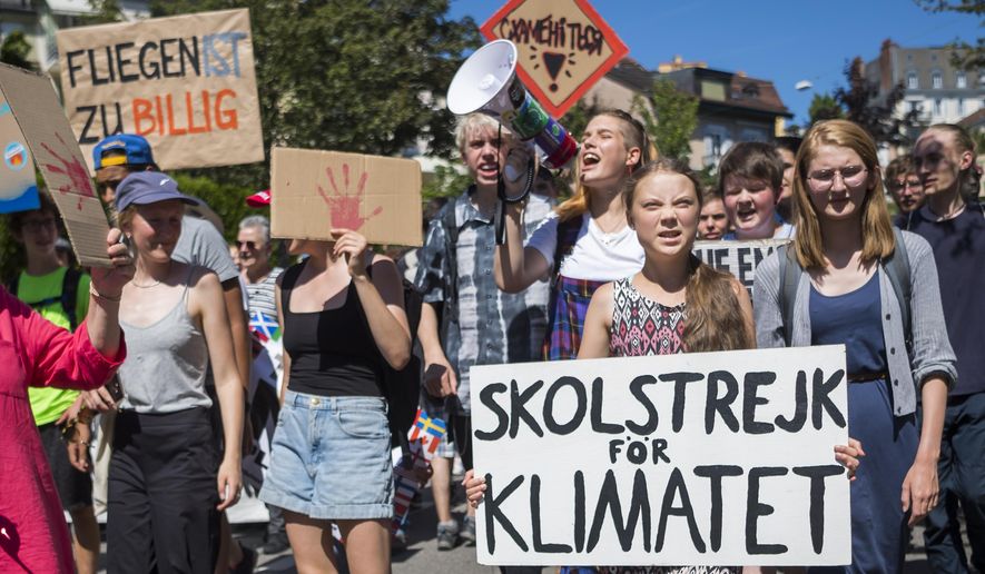 Swedish climate activist Greta Thunberg reacts with other young climate activists during a demonstration against climate change on the closing day of the «' Smile for Future Summit for climate' », in Lausanne, Switzerland, Friday, Aug. 9, 2019. More than 450 participants from 37 different countries met this week in Lausanne for the summer gathering of the «' Fridays for Future' » movement. (Jean-Christophe Bott/Keystone via AP)
