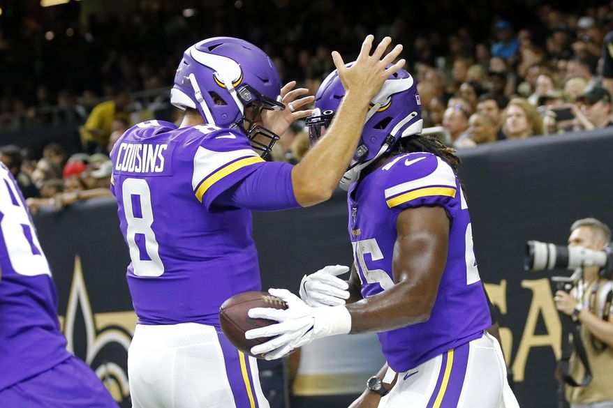Minnesota Vikings quarterback Kirk Cousins (8) celebrates his touchdown pass to running back Alexander Mattison (25) in the first half of an NFL preseason football game against the New Orleans Saints in New Orleans, Friday, Aug. 9, 2019. (AP Photo/Gerald Herbert)