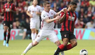 Sheffield United&#x27;s John Fleck, left, and Bournemouth&#x27;s Joshua King tussle for the ball during the English Premier League soccer match between Bournemouth and Sheffield United at the Vitality Stadium, Bournemouth, England. Saturday, Aug, 10 2019. (Mark Kerton/PA via AP)