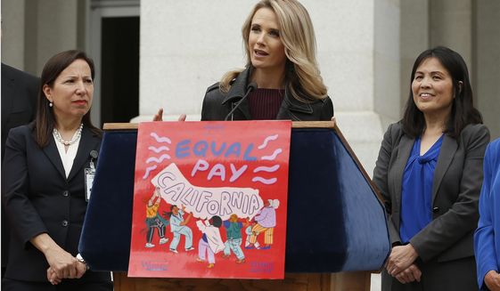 FILE -- In this April 1, 2019 file photo California first partner Jennifer Siebel Newsom, center, the wife of Gov. Gavin Newsom, joined others to to announce the #EqualPayCA campaign, in Sacramento, Calif. Siebel Newsom has shunned the traditional title of &amp;quot;first lady&amp;quot; and is focusing on women&#39;s issues including equal pay and expanding family leave. (AP Photo/Rich Pedroncelli, File)