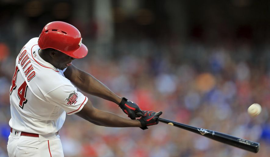 Cincinnati Reds&#39; Aristides Aquino hits a solo home run, his second home run of the game, in the third inning of a baseball game against the Chicago Cubs, Saturday, Aug. 10, 2019, in Cincinnati. (AP Photo/Aaron Doster)