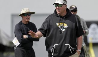 FILE - In this June 12, 2019, file photo, Jacksonville Jaguars head coach Doug Marrone, front, directs an NFL football practice, Wednesday, June 12, 2019, in Jacksonville, Fla., as Tom Coughlin, left, executive vice president of football operations for the Jaguars, looks on. Coughlin and Marrone are pretty much taking it easy on the Jaguars. It&#39;s a complete about-face for two old-school coaches who seem to take pleasure in grinding guys into the ground. (AP Photo/John Raoux, File)