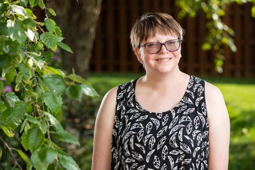 Erin Phillips, who has developmental disabilities, poses at her extended family home Tuesday, July 30, 2019, in Lincoln, Neb. Phillips is a disability policy advocate for People First of Nebraska. (Brendan Sullivan/The World-Herald via AP)