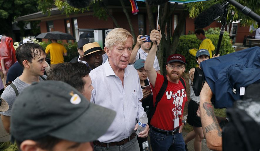 Republican presidential candidate and former Massachusetts Gov. Bill Weld, center, walks to the grand concourse during a visit to the Iowa State Fair, Sunday, Aug. 11, 2019, in Des Moines, Iowa. (AP Photo/Charlie Neibergall)