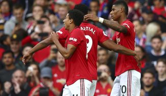 Manchester United&#x27;s Marcus Rashford, right, celebrates with teammates after scoring his sides first goal during the English Premier League soccer match between Manchester United and Chelsea at Old Trafford in Manchester, England, Sunday, Aug. 11, 2019. (AP Photo/Dave Thompson)